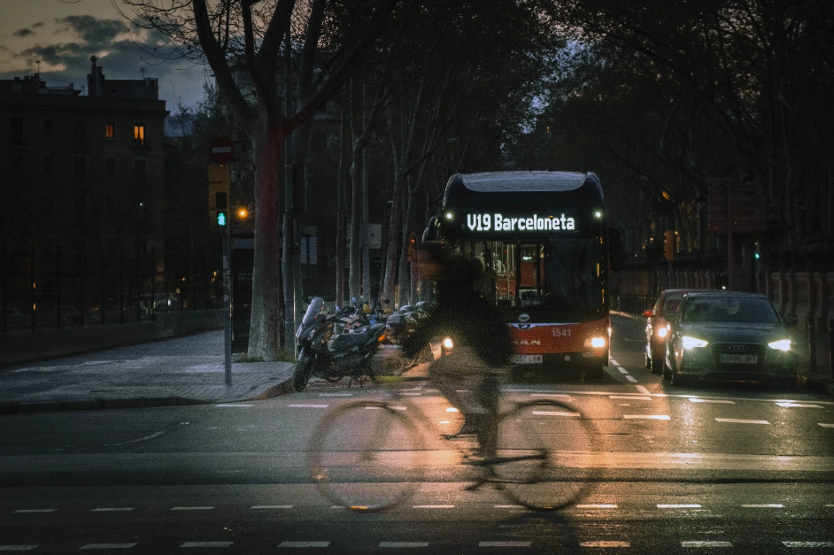 Movilidad sostenible. Ciclista y bus se cruzan en Barcelona. Foto de Pere Jurado (Unsplash)